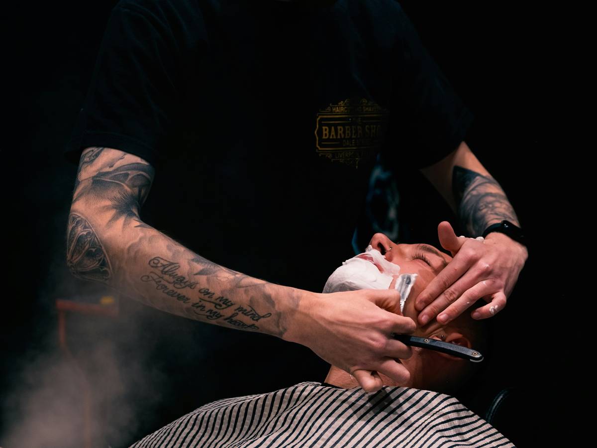 Side-by-side comparison: blunt kitchen scissors vs. professional precision beard scissors showing clean cut vs. crushed hair ends under magnification