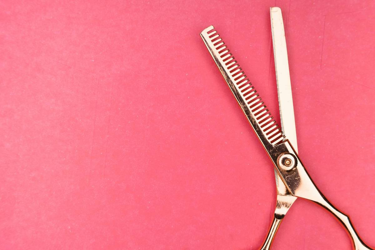 Side-by-side comparison: fine-toothed vs. wide-toothed beard scissors gripping hair strands